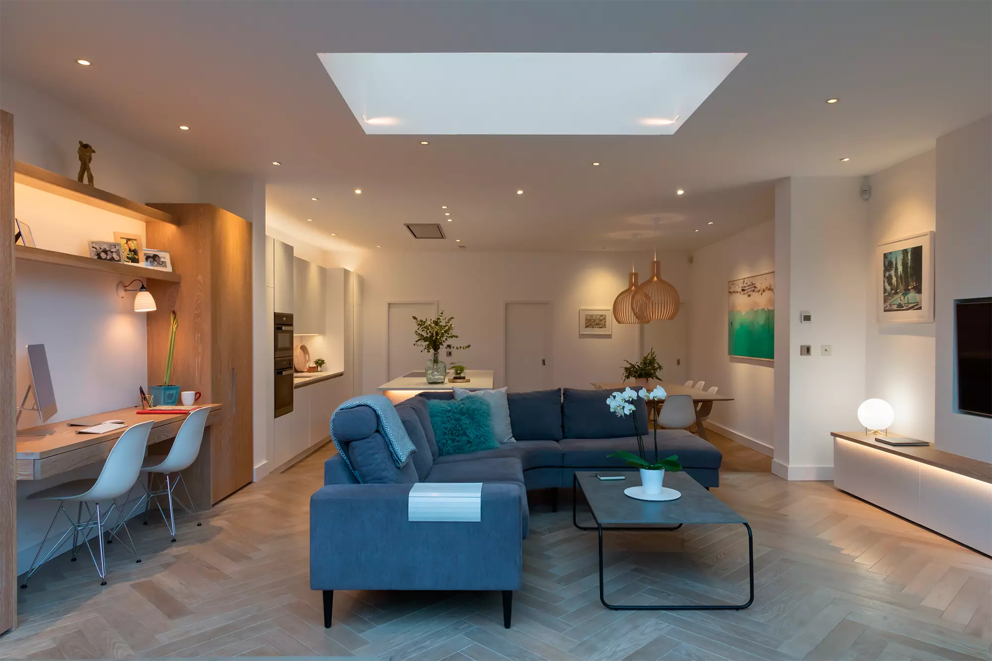 A modern well lit living room featuring multiple lighting sources including recessed ceiling lights a large skylight - 50+ Inspiring Living Room Lighting Ideas for May 2026 - Vorlane