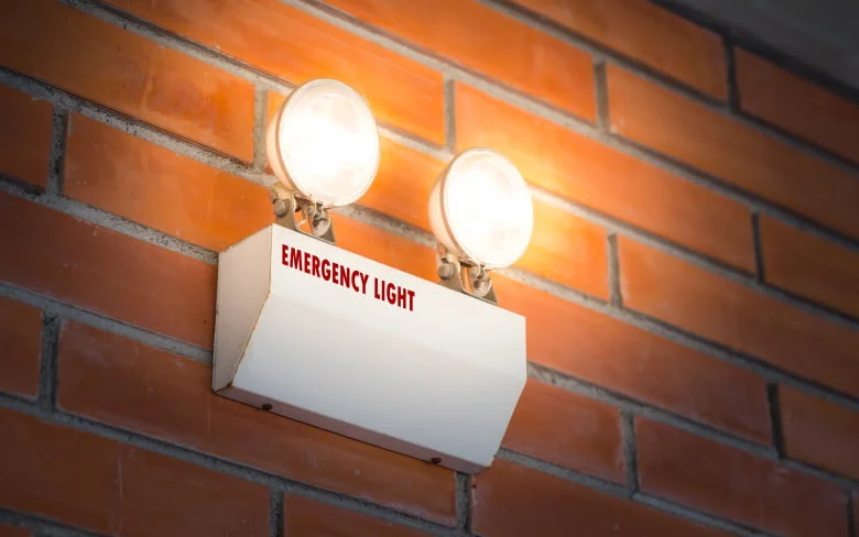 Illuminated brick wall with two lights white light glowing Picture included in A Guide to Emergency Lighting - A Guide to Emergency Lighting - Vorlane - Vorlane