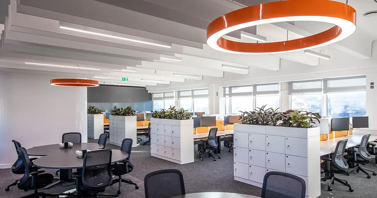 Office with orange lighting and black chairs meeting UK Workplace Lighting Regulations - Workplace Lighting Regulations in the UK: Ensuring Safety and Productivity - Vorlane - Vorlane